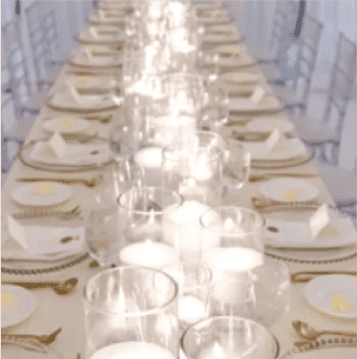 candles set up on long dinner table