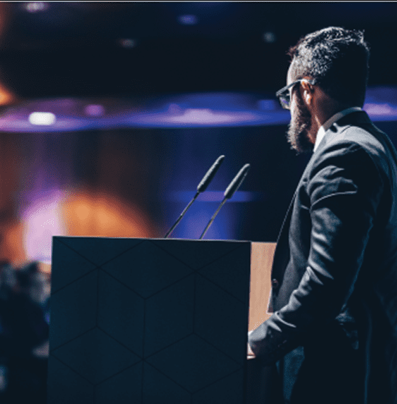 male speaker at podium giving a speech