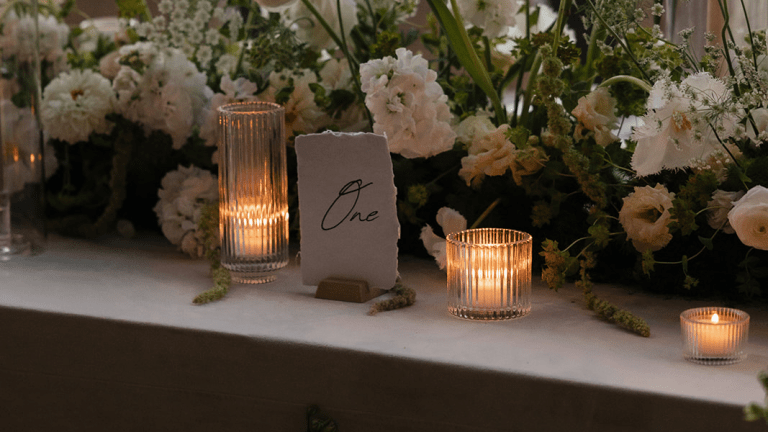 Votives Surrounded by Greenery on reception table
